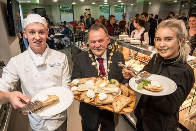 Mayor of Derry and Strabane District Council Maoliosa McHugh serves the first breakfast at North West Regional College's newly refurbished Flying Clipper Brasserie, with help from Hospitality and Catering students Calum Falls and Siobhan Walton. (Picture by Martin McKeown).