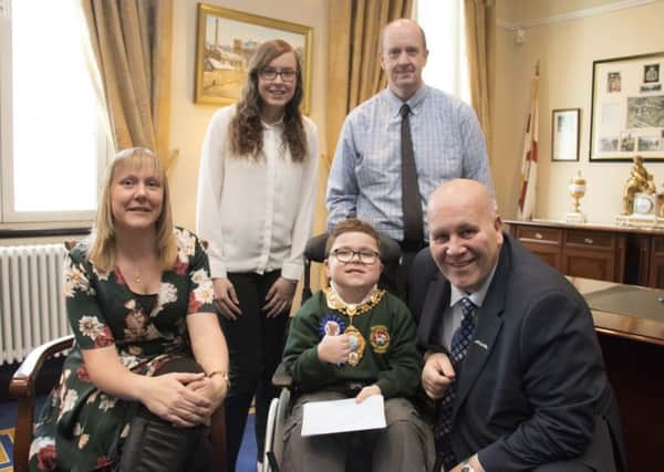 Ethan and his family are pictured with Mayor of Mid and East Antrim Borough Council, Cllr Paul Reid.  INBT 38-720-CON