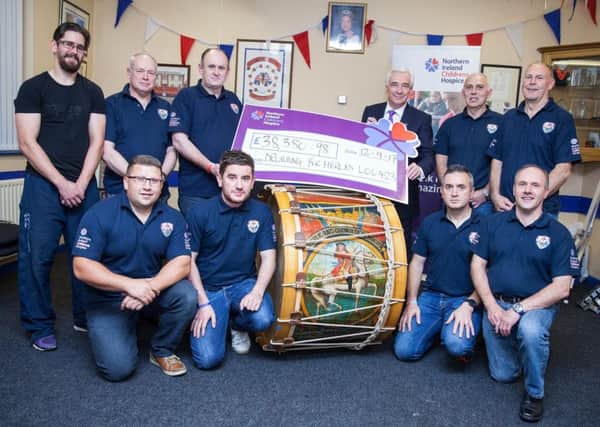 Members of Banbridge Bible and Crown Defenders LOL 423 who took part in the charity fundraising climb present the proceeds to Northern Ireland Hospice president, Paul Clark