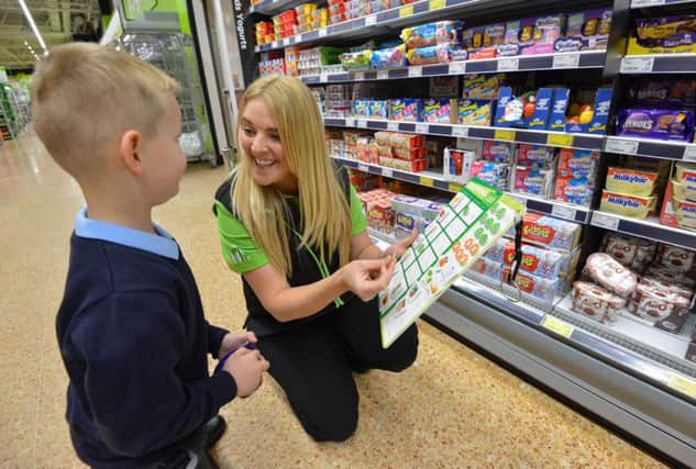 The Happy Little Helpers scheme, which encourages young children to get involved with shopping, is being introduced into Asda stores next week. This picture shows Asda colleague Jenny Barnett who came up with the idea of the list with her five-year-old son Charlie.