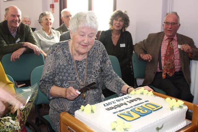 Margaret Franklin, one of the group's Trustees cuts the celebration cake made by Hon Secretary Teresa Connor. INCT 40-745-CON