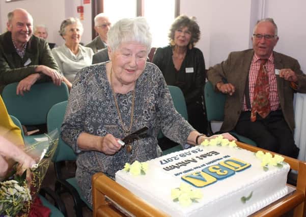Margaret Franklin, one of the group's Trustees cuts the celebration cake  made by Hon Secretary Teresa Connor.  INCT 40-745-CON