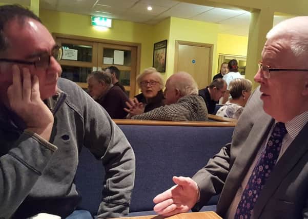 Stewart Dickson in discussion with a local resident at the Neighbourhood Watch event in Greenisland on Monday evening.  INCT 39-720-CON