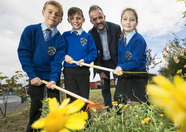 Ross Marsden, James McConville and Jessica Canavan from St Francis Primary School Lurgan along with Richard Rogers from the Alpha Programme plan ahead with Â£22,100 from the programme. The funding will create will create growing space and include a polytunnel, raised beds, fencing, paving and an outdoor classroom area.