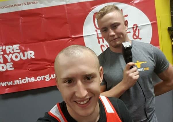 Andrew Falconer has his head shaved by challenge victor Vincent McCorry.
