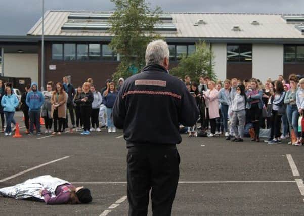 Station Commander Dennis Auld, Glengormley Fire Station speaking to students at Northern Regional College Newtownabbey during the simulated car crash road safety demonstration.