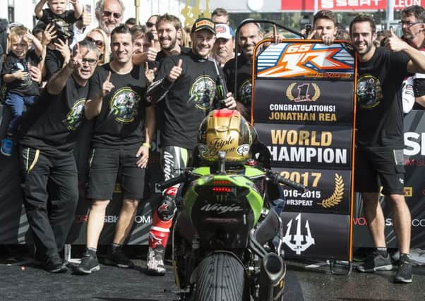 Jonathan Rea celebrates with his Kawasaki team at Magny-Cours in France on Saturday after winning a record third successive World Superbike Championship.