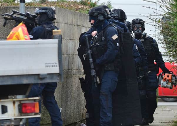 Heavily armed police in the Woodburn area following the shooting in March. 
Photo Arthur Allison/Pacemaker Press