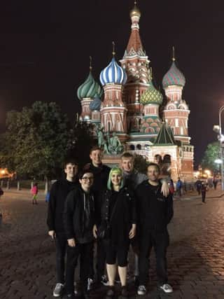 Aaron Black (left) with fellow band members Jonny, Carl, Melyssa, Matty and their sound engineer Mike outside St. Basils Cathedral in Moscow.