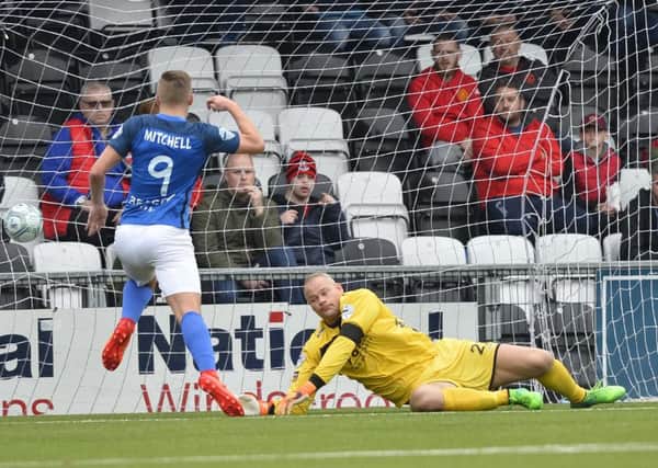 Andrew Mitchell slots home to increase Glenavon's lead over Crusaders. Pic by Pacemaker Ltd.