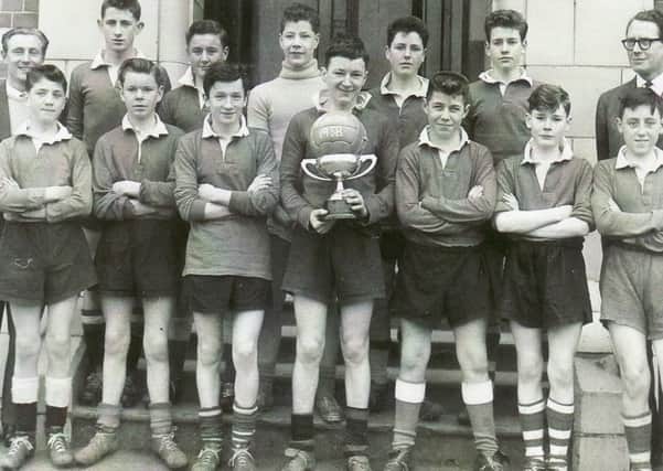 Mr Sidney Proctor, back left, with one of the many Portadown Technical cup-winning teams. Back row, Mervyn Haire, George Pollock, Noel Milsopp, Brian Armstrong, Brian Cully, Mr R A Robb. Front from left, Brian Hyndes, Tom Hynes, Raymond McLoughlin, Jack McCann, Denis Guy, Eric Black and Ronnie Redpath.