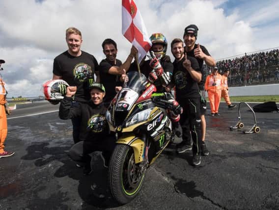Jonathan Rea celebrates his record third successive World Superbike title in France.