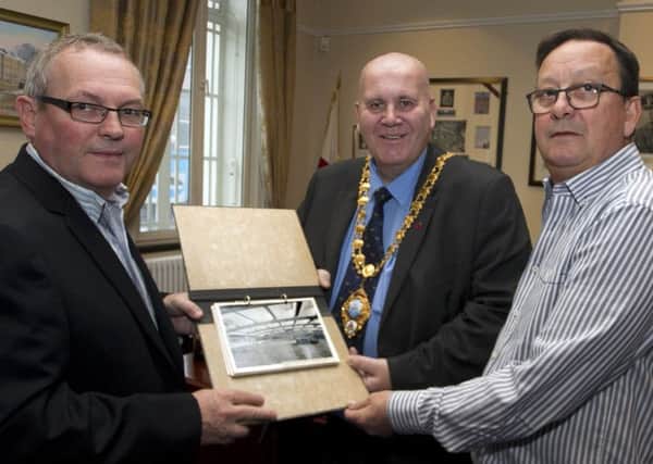 Mayor of Mid & East Antrim Council, Cllr Paul Reid pictured at the Braid Museum looking over some old photographs of Gallaghers along with Greg McKinley and Rodney Stewart (JTI).