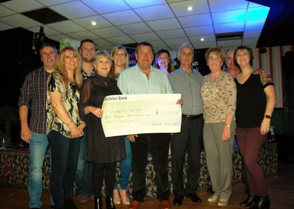 Harry Irvine and supporters at the cheque presentation in McConnell's of Doagh