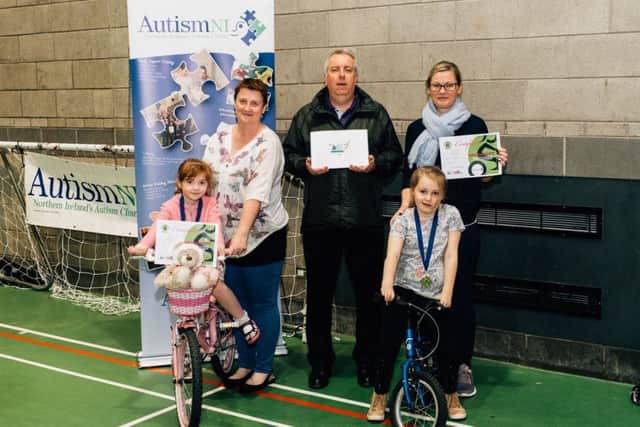 Peter Mullan from NIE Networks Charities Fund presents children from Autism NI Mid Ulster Support Group with certificates and medals following a six-week Balanceability enabling children with Autism to learn how to ride their bicycles.