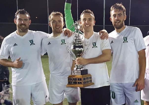 Aaron King, Mark O'Kane, Daniel Gavin and Damien McGee, who played their part in Toronto Harps remarkable unbeaten season, celebrate the recent TSSL Cup success.