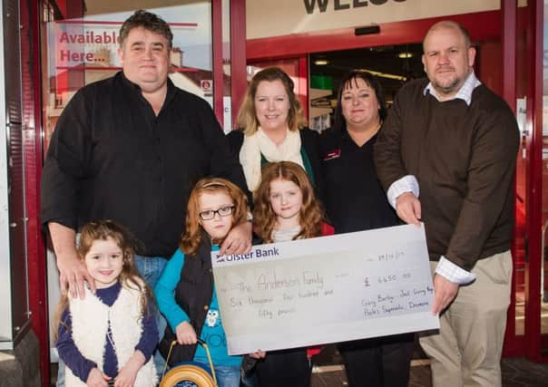 The Anderson family - Tom, Heidi, Mary, Tess and Kate - receive a cheque for Â£6,450 from fundraising campaign organisers Karen Long (second from right) and Gary Barlow (right). The money was raised in memory of the Andersons' eldest daughter Isobel, who tragically passed away in September this year.
