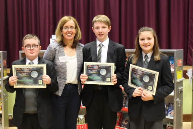 Brian Sands-McAllister, Oliver Carvill joint runners up and Tierna Doran first place with Mrs McCann Head of English  at the St Patrick's Academy coffee morning and book fair