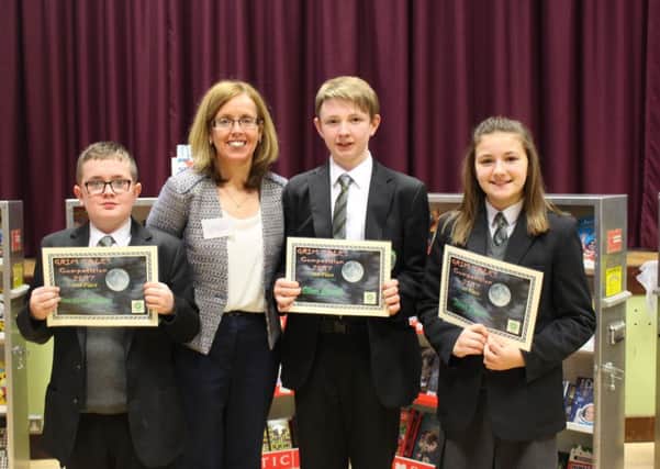 Brian Sands-McAllister, Oliver Carvill joint runners up and Tierna Doran first place with Mrs McCann Head of English  at the St Patrick's Academy coffee morning and book fair
