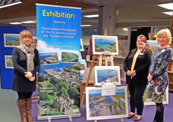 Pictured at the aerial Photography Exhibition which is on display in Larne Library until November 25 is  Lucy Steele (left) and library staff.