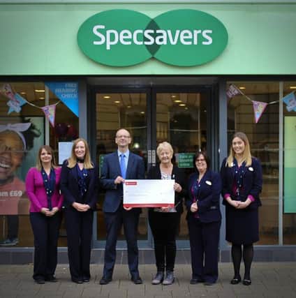 Mervyn Thompson (centre) event director of the Specsavers backed Portrush 5 Mile Road Race presents Alison McCullough (3rd right) from Prostate Cancer UK with a cheque for Â£1000. Also pictured from the Specsavers Coleraine team are (l-r) Laura Drain, Lynn Mackey, Michelle Crampsie and Shannon Robinson.