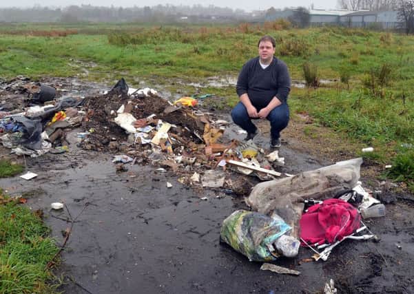 John Creaney of the SDLP pictured at the scene of fly tipping near to Churchill Park/Woodside Green. INPT45-260.