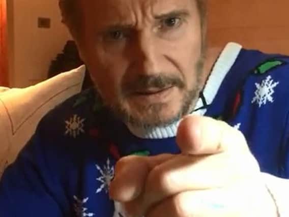 Ballymena's Liam Neeson wears a Christmas jumper in the video.